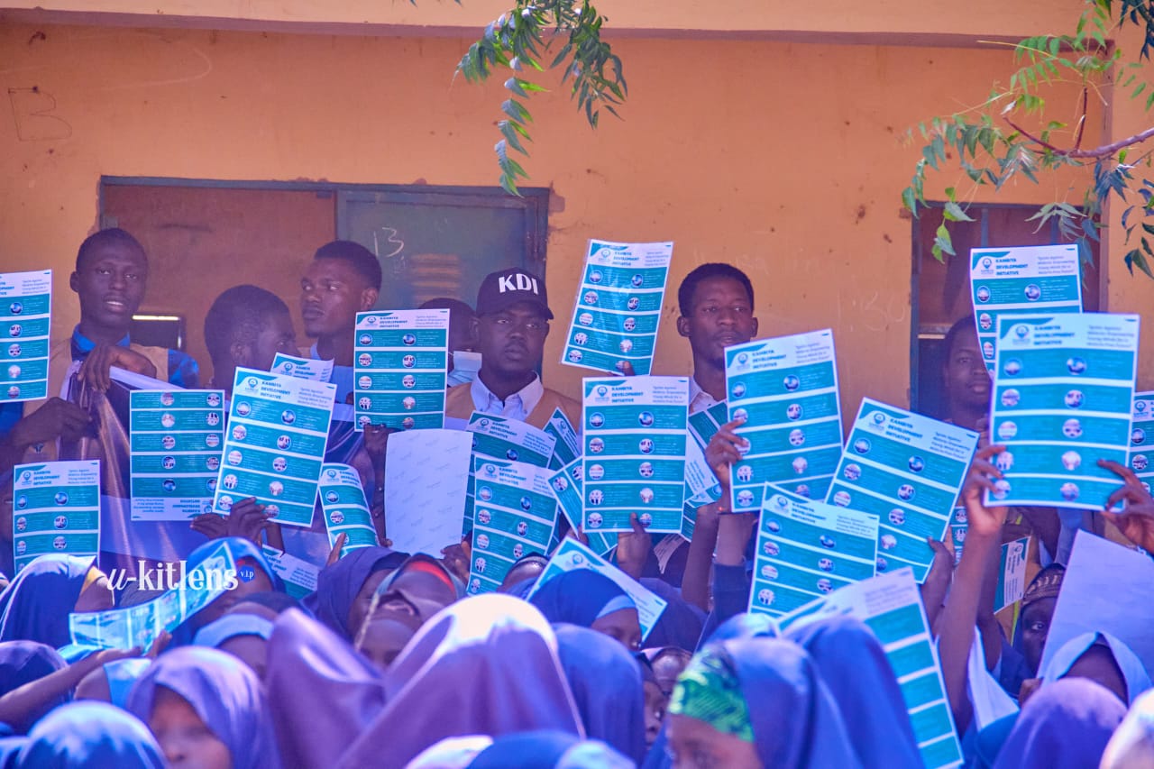 Students and KDI team raising Ignite Against Malaria flyers